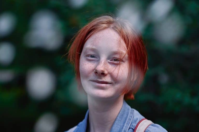 a woman with red hair is smiling for the camera