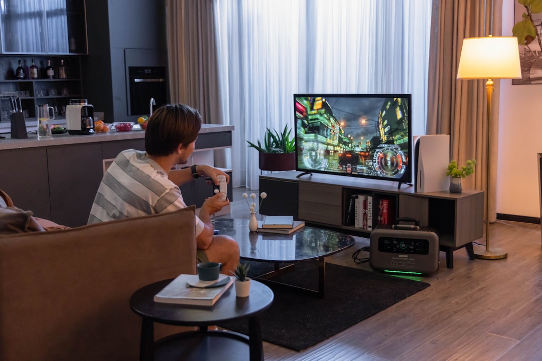 a man sitting in a chair in front of a tv