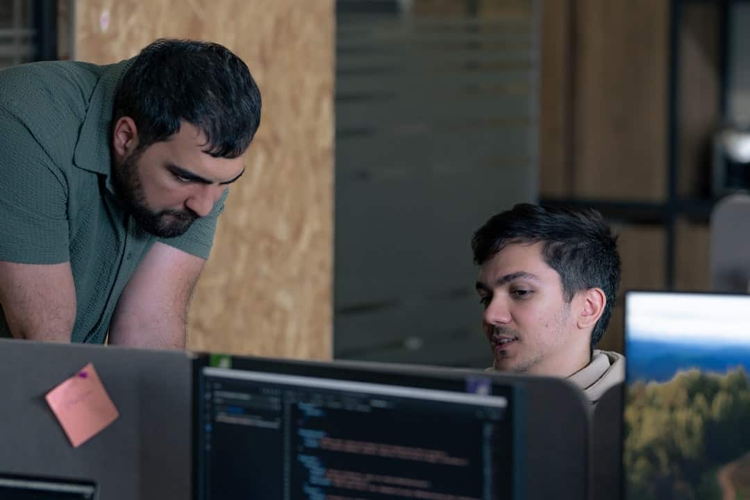 Two men working on computers in an office